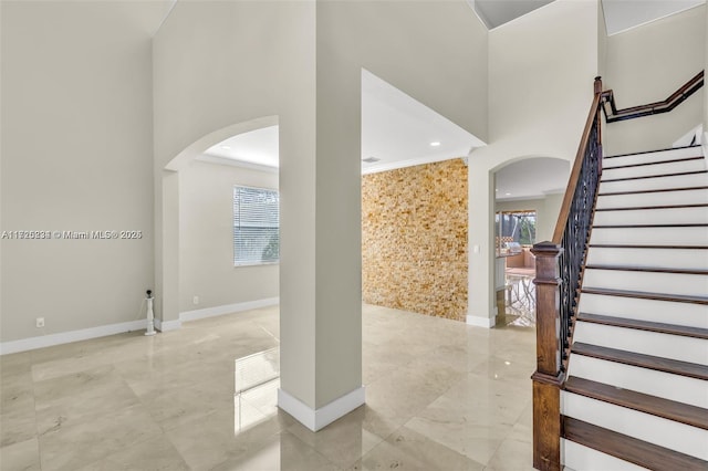 entrance foyer featuring ornamental molding