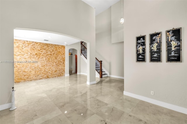 interior space featuring a towering ceiling