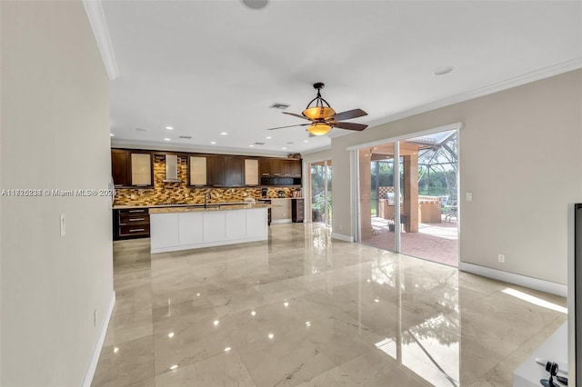 interior space featuring ceiling fan, crown molding, and sink