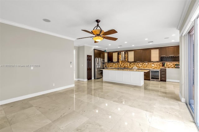 kitchen with stainless steel refrigerator with ice dispenser, decorative backsplash, a kitchen island, beverage cooler, and ornamental molding