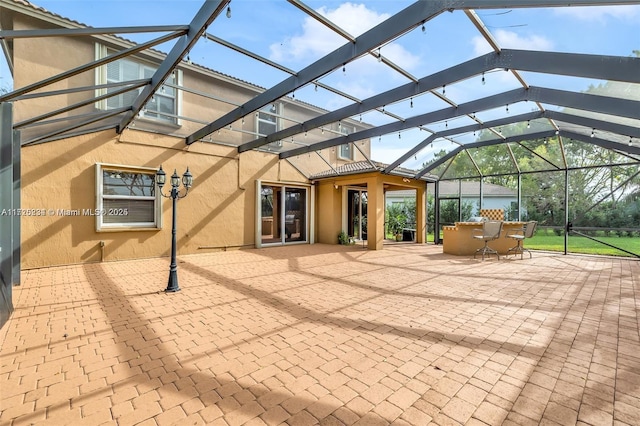 view of patio / terrace featuring a lanai and exterior bar