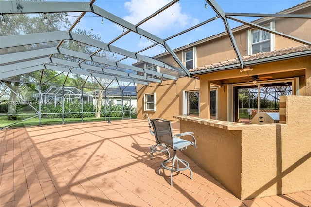 view of patio featuring a lanai