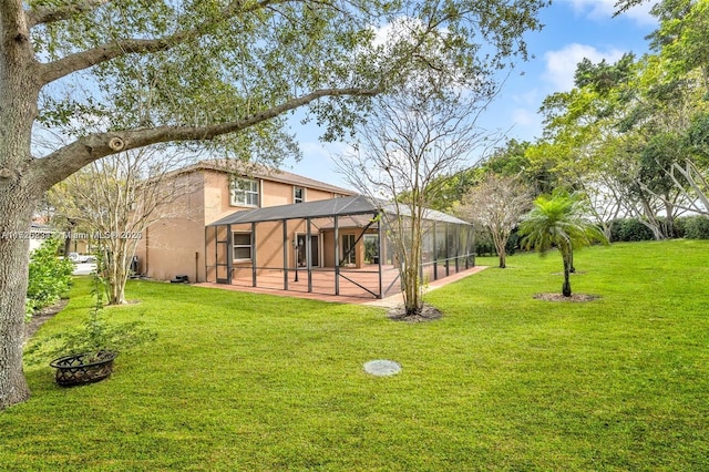 view of yard with a patio area and glass enclosure