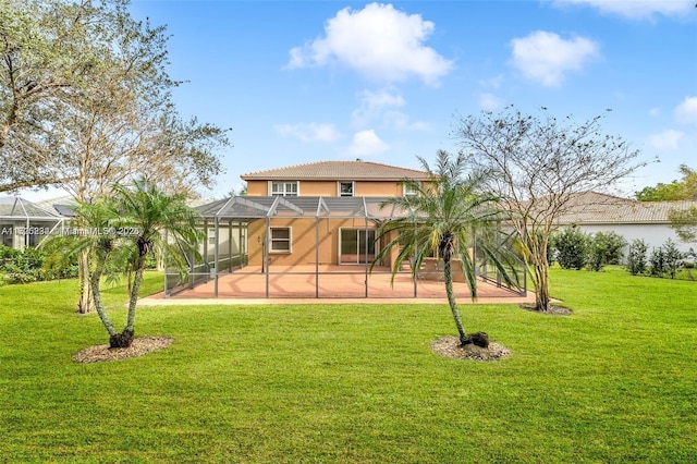 rear view of house featuring a lanai, a patio area, and a lawn