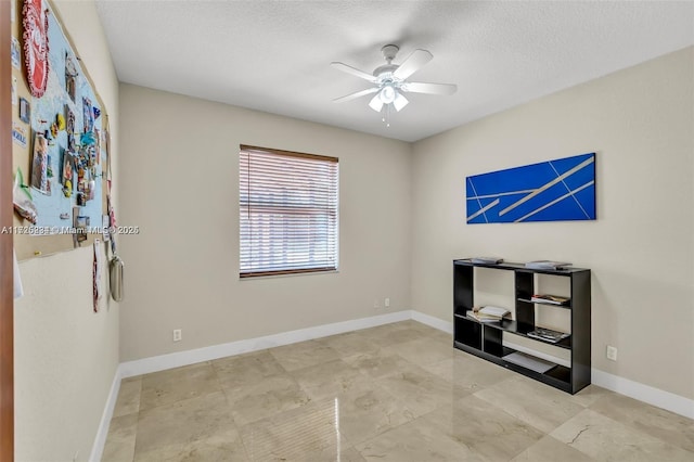 interior space featuring a textured ceiling and ceiling fan