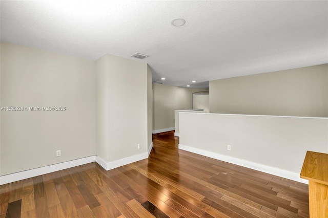 unfurnished room featuring dark wood-type flooring