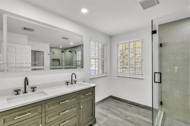 bathroom featuring a shower with shower door, wood-type flooring, and vanity