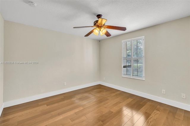 empty room featuring wood-type flooring, a textured ceiling, and ceiling fan