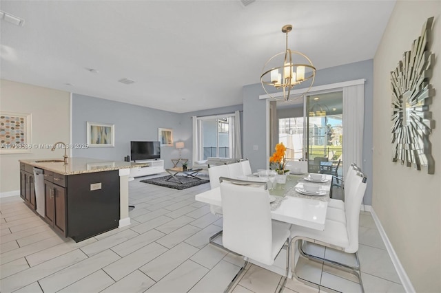 dining room featuring sink and a notable chandelier