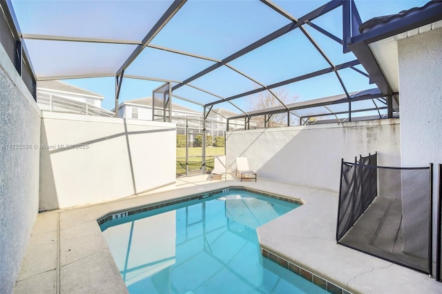 view of swimming pool featuring a patio area and glass enclosure