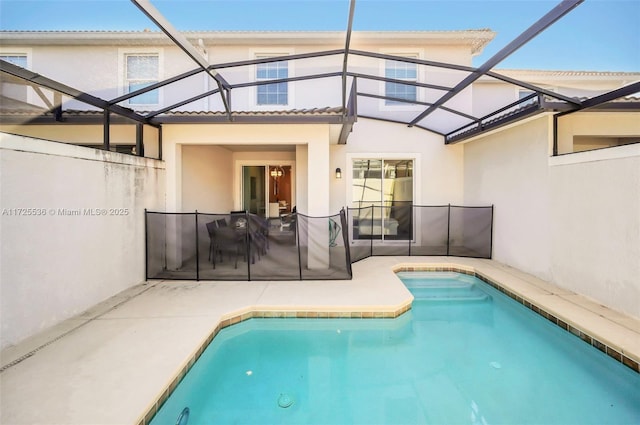 back of house featuring a lanai and a patio