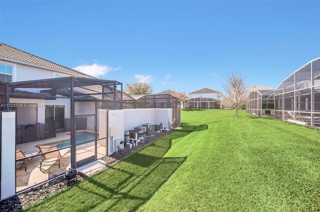 view of yard featuring a patio area, a lanai, and a fenced in pool