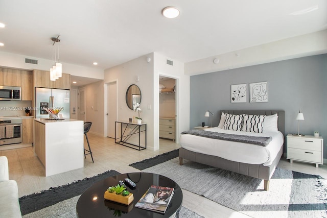 bedroom featuring a spacious closet, a closet, and stainless steel refrigerator with ice dispenser