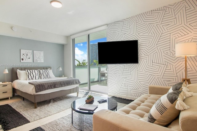 bedroom featuring access to exterior and floor to ceiling windows