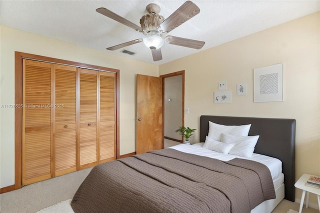 carpeted bedroom featuring a closet and ceiling fan