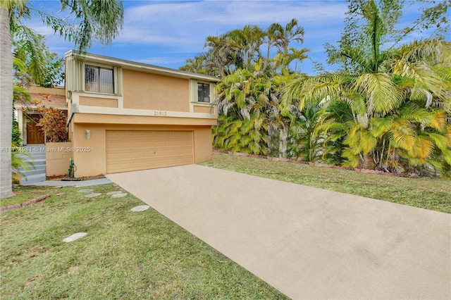 view of front of house with a garage and a front lawn