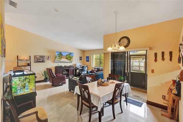 dining area with a chandelier and light tile patterned floors