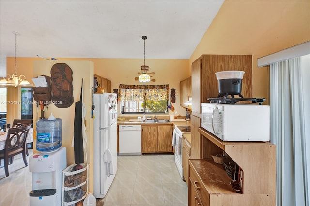 kitchen featuring lofted ceiling, hanging light fixtures, light tile patterned floors, white appliances, and an inviting chandelier