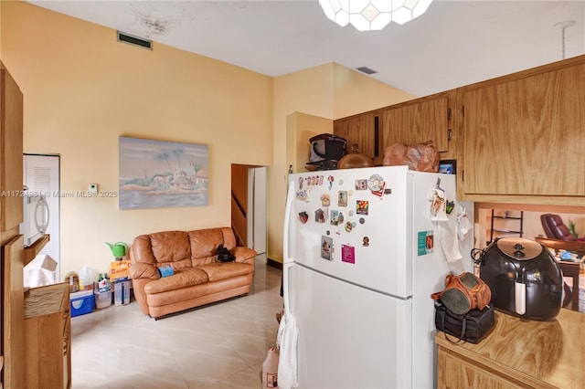 kitchen featuring white fridge and light tile patterned floors