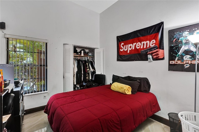 bedroom with multiple windows and a closet