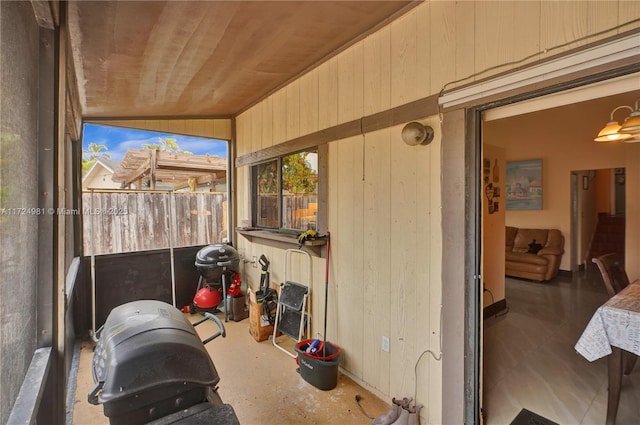 sunroom with lofted ceiling and wooden ceiling