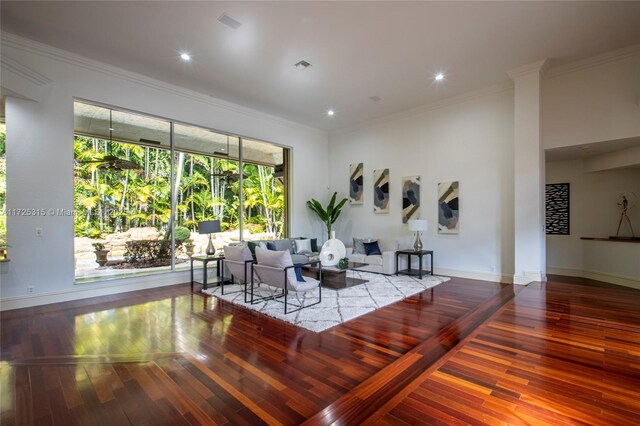 living room with hardwood / wood-style flooring and ornamental molding