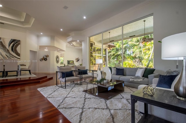living area featuring wood-type flooring, baseboards, ornamental molding, and recessed lighting
