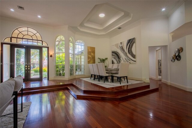 dining room with wood finished floors and ornamental molding