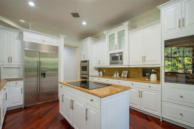 kitchen featuring a breakfast bar area, dark wood-style floors, recessed lighting, and light stone counters