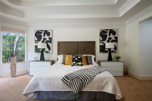 carpeted bedroom with ornamental molding, a tray ceiling, and baseboards