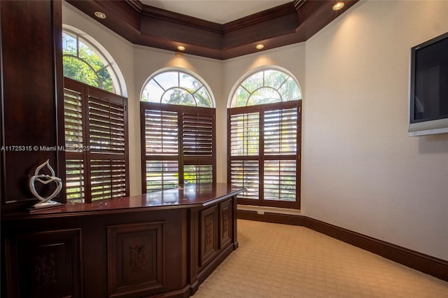 office space featuring a wealth of natural light, crown molding, and baseboards