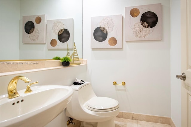 bathroom featuring toilet and a sink