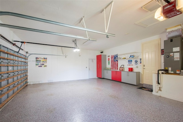 garage featuring heating unit and a garage door opener