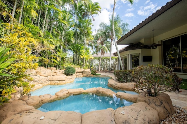 outdoor pool with a ceiling fan