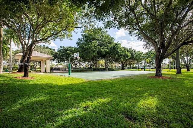 view of community with community basketball court and a yard