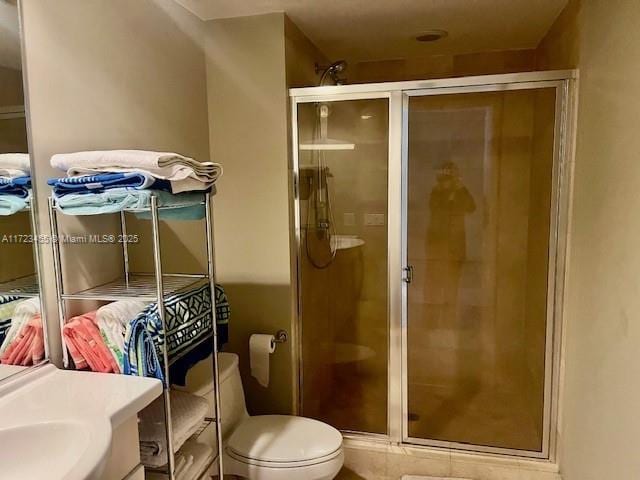 bathroom with vanity, a shower with shower door, and toilet