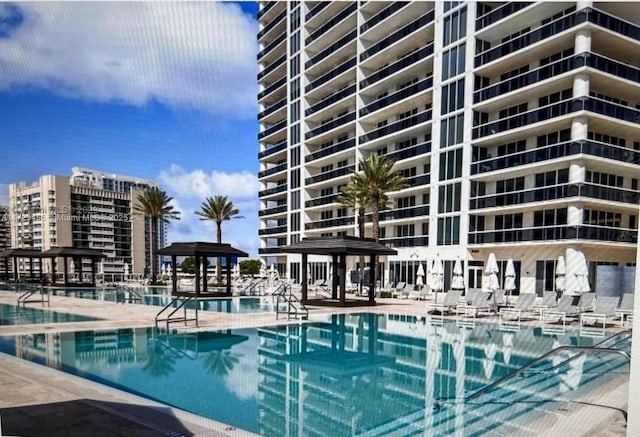 view of pool with a patio and a gazebo