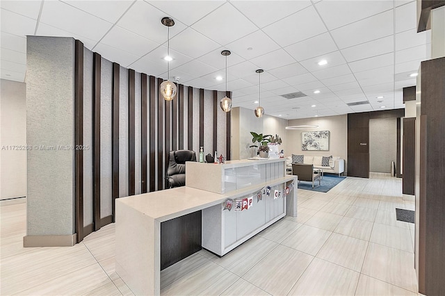 kitchen featuring pendant lighting and a paneled ceiling