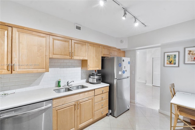 kitchen featuring stainless steel appliances, sink, light tile patterned flooring, light brown cabinetry, and backsplash