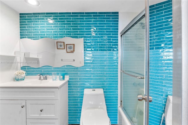 full bathroom with toilet, shower / bath combination with glass door, and vanity