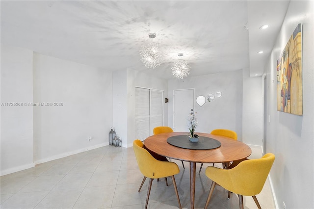 tiled dining space featuring a chandelier