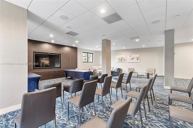 interior space with carpet flooring and a drop ceiling