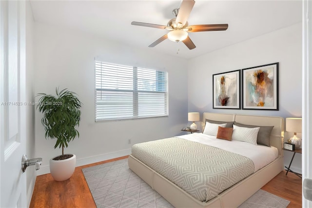 bedroom with ceiling fan and light hardwood / wood-style flooring