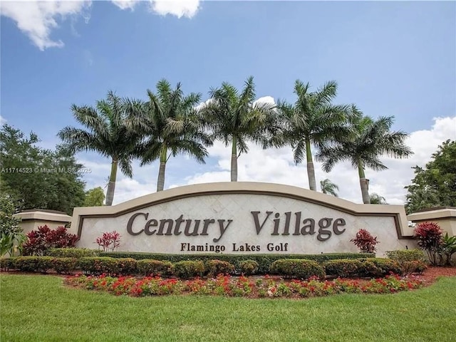 community sign featuring a yard