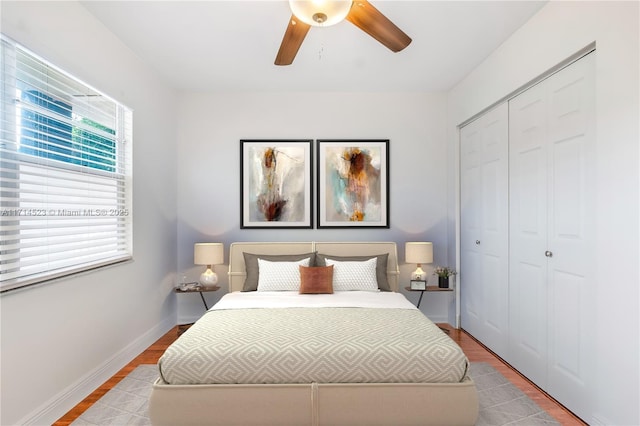 bedroom featuring light hardwood / wood-style floors, a closet, and ceiling fan