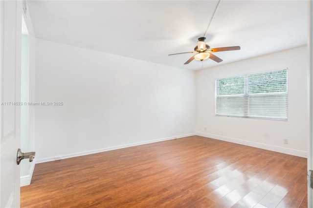 empty room featuring hardwood / wood-style floors and ceiling fan