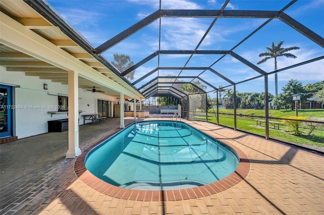 view of swimming pool with a lanai, a jacuzzi, and a patio area