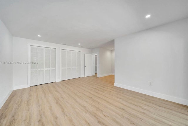 interior space featuring light hardwood / wood-style flooring and multiple closets