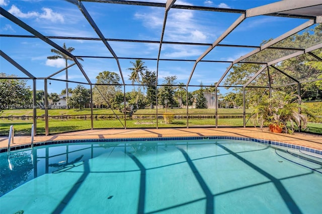 view of pool with a yard, glass enclosure, and a patio area