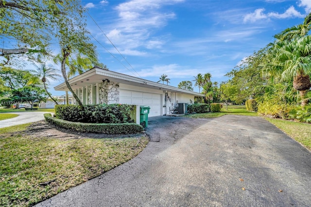 view of home's exterior featuring cooling unit and a garage